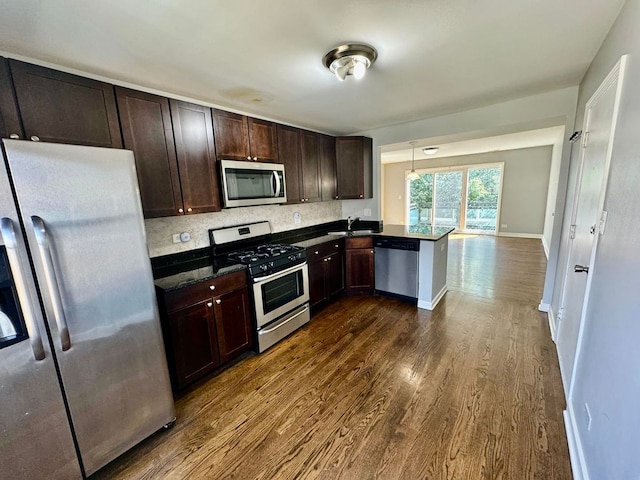 6433 N Damen Ave Unit 3E, Chicago, IL 60645 - kitchen with appliances with stainless steel finishes, dark wood-type flooring, dark brown cabinetry, a peninsula, and backsplash