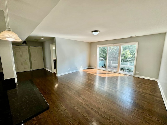 6433 N Damen Ave Unit 3E, Chicago, IL 60645 - unfurnished living room with baseboards and dark wood-style floors