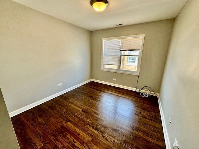 6433 N Damen Ave Unit 3E, Chicago, IL 60645 - spare room with dark wood-style floors and baseboards
