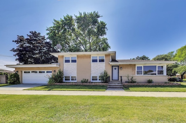 7203 W Lill St, Niles, IL 60714 - split level home with an attached garage, a front lawn, driveway, and stone siding