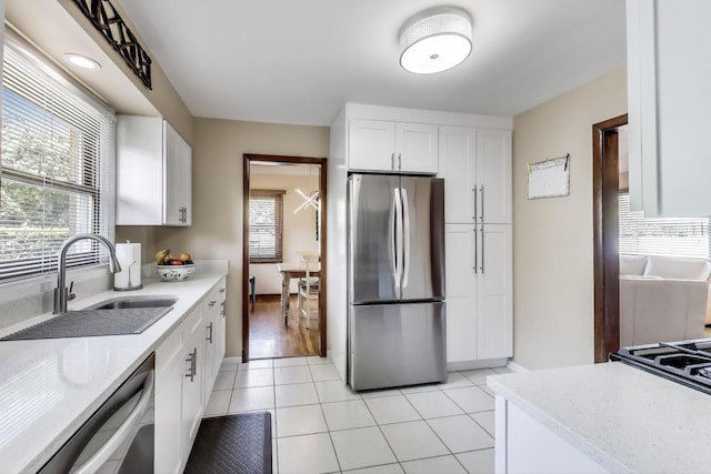 7203 W Lill St, Niles, IL 60714 - kitchen with stainless steel appliances, plenty of natural light, white cabinets, and light tile patterned floors