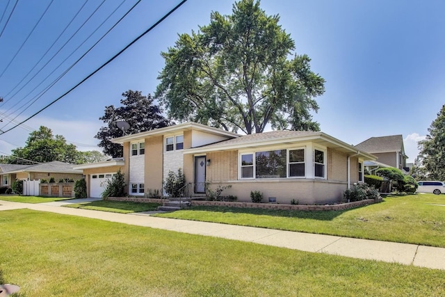 7203 W Lill St, Niles, IL 60714 - tri-level home with brick siding, a garage, a front yard, and concrete driveway