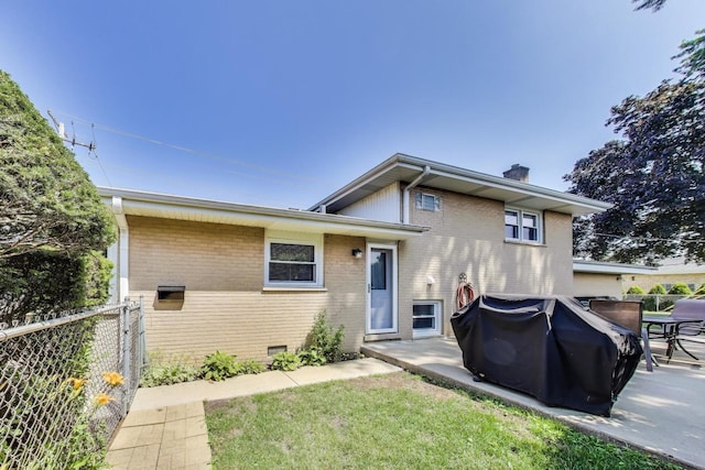 7203 W Lill St, Niles, IL 60714 - view of front of home with brick siding, a chimney, and a patio