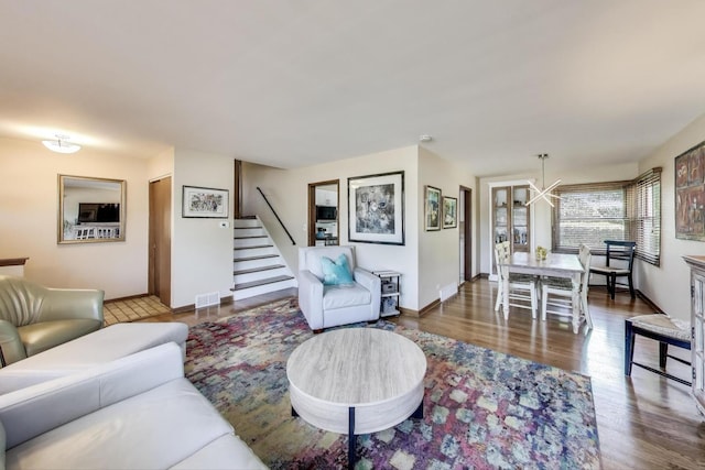 7203 W Lill St, Niles, IL 60714 - living area featuring a chandelier, stairs, and wood finished floors