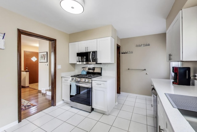 7203 W Lill St, Niles, IL 60714 - kitchen featuring stainless steel appliances, light countertops, white cabinets, and light tile patterned floors