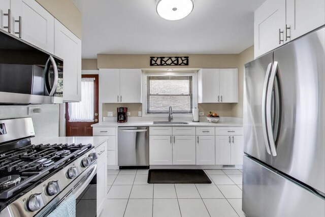 7203 W Lill St, Niles, IL 60714 - kitchen featuring appliances with stainless steel finishes, light countertops, white cabinetry, and light tile patterned floors