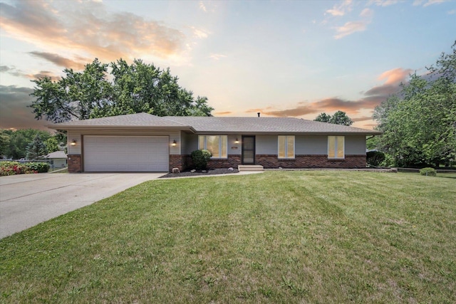 11740 Wagon Ln, Roscoe, IL 61073 - ranch-style house with brick siding, an attached garage, concrete driveway, and a yard