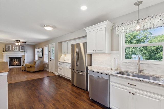 11740 Wagon Ln, Roscoe, IL 61073 - kitchen with appliances with stainless steel finishes, white cabinetry, ceiling fan, backsplash, and recessed lighting