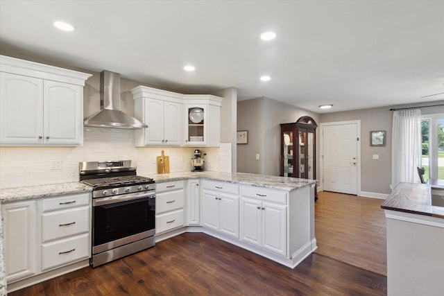 11740 Wagon Ln, Roscoe, IL 61073 - kitchen featuring gas range, wall chimney exhaust hood, a peninsula, backsplash, and dark wood-type flooring