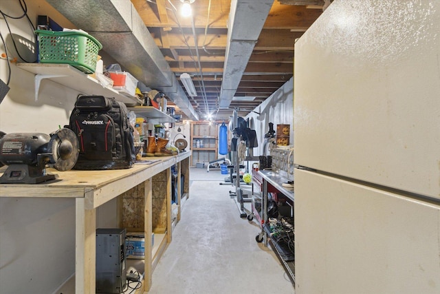 11740 Wagon Ln, Roscoe, IL 61073 - unfinished below grade area with freestanding refrigerator and a workshop area