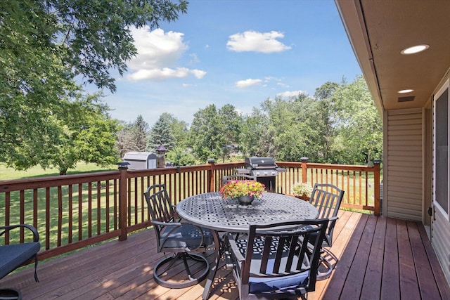 11740 Wagon Ln, Roscoe, IL 61073 - wooden deck with a storage unit, outdoor dining area, and a yard