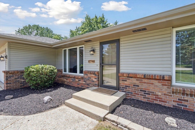 11740 Wagon Ln, Roscoe, IL 61073 - property entrance featuring brick siding and a shingled roof