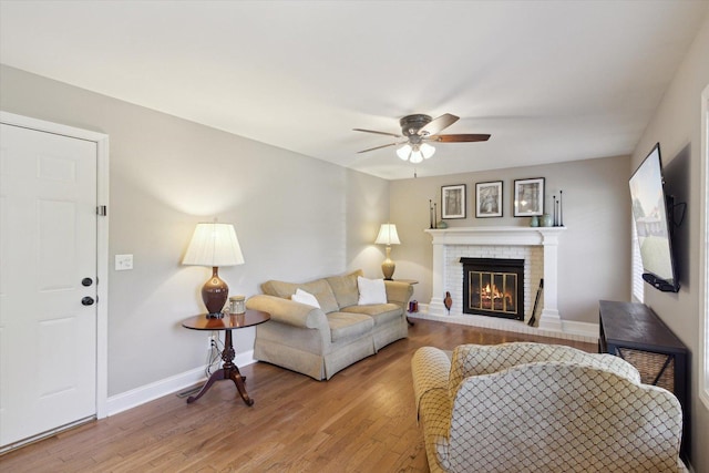 11740 Wagon Ln, Roscoe, IL 61073 - living room featuring a ceiling fan, light wood finished floors, and a brick fireplace