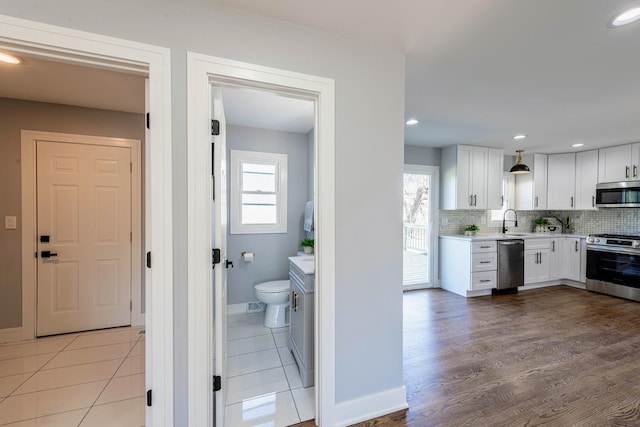 22W046 Mccormick Ave, Glen Ellyn, IL 60137 - kitchen featuring appliances with stainless steel finishes, light countertops, white cabinetry, plenty of natural light, and recessed lighting