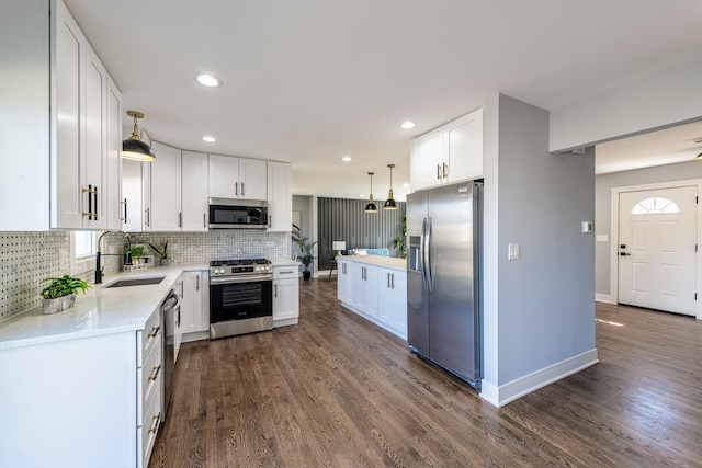 22W046 Mccormick Ave, Glen Ellyn, IL 60137 - kitchen featuring stainless steel appliances, white cabinets, tasteful backsplash, dark wood finished floors, and recessed lighting