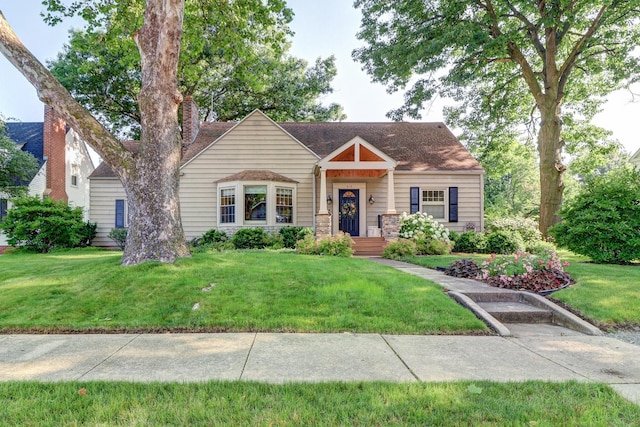 410 W 12th St, Sterling, IL 61081 - view of front of home featuring a front yard and a shingled roof