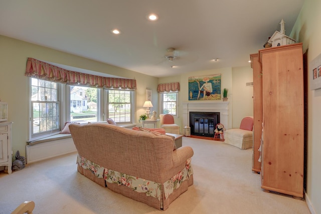 410 W 12th St, Sterling, IL 61081 - living area featuring light colored carpet, recessed lighting, a ceiling fan, and a fireplace with flush hearth