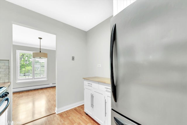 461 N Jonathan Dr Unit 204, Palatine, IL 60074 - kitchen with freestanding refrigerator, a baseboard radiator, white cabinetry, light countertops, and light wood-style floors