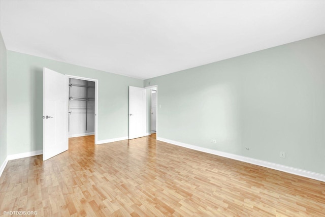 461 N Jonathan Dr Unit 204, Palatine, IL 60074 - unfurnished bedroom with light wood-style floors, a spacious closet, and a closet