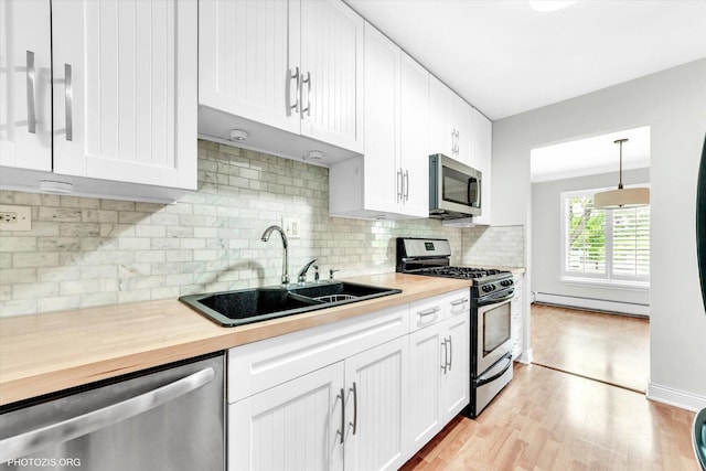 461 N Jonathan Dr Unit 204, Palatine, IL 60074 - kitchen with stainless steel appliances, wooden counters, baseboard heating, light wood-style flooring, and white cabinets