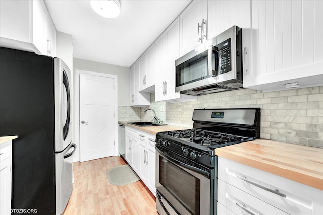 461 N Jonathan Dr Unit 204, Palatine, IL 60074 - kitchen featuring stainless steel appliances, light wood finished floors, backsplash, white cabinets, and wood counters