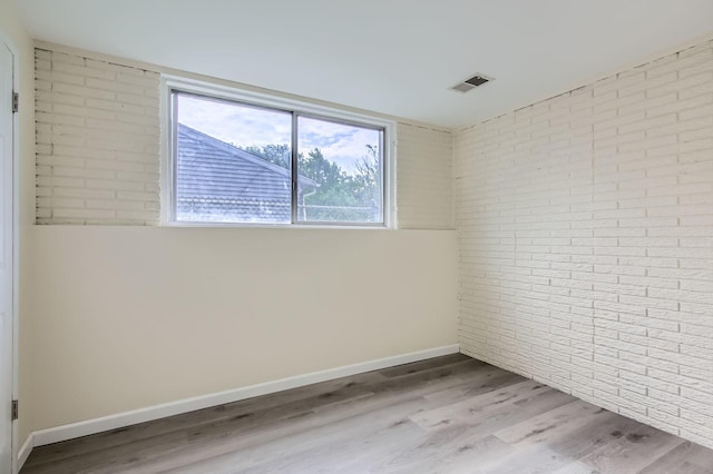 4723 Lee Ct, Richton Park, IL 60471 - unfurnished room featuring brick wall and wood finished floors