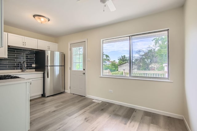 4723 Lee Ct, Richton Park, IL 60471 - kitchen with freestanding refrigerator, light countertops, light wood-style flooring, and white cabinetry
