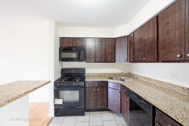 2030 W 111th St Unit 207, Chicago, IL 60643 - kitchen featuring black appliances, dark brown cabinets, and light stone counters
