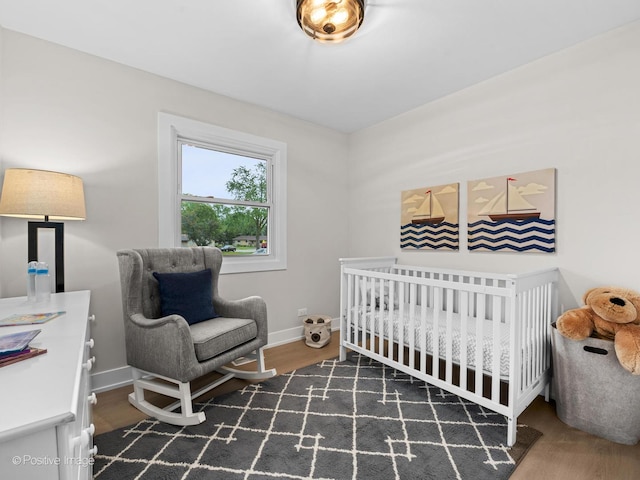 6950 Longmeadow Ln, Hanover Park, IL 60133 - bedroom featuring wood finished floors and a nursery area