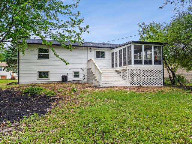 6950 Longmeadow Ln, Hanover Park, IL 60133 - rear view of house featuring a sunroom, stairway, and a yard