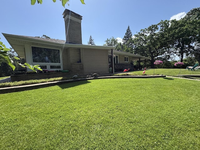26575 N Fairfield Rd, Wauconda, IL 60084 - rear view of house featuring a chimney and a lawn