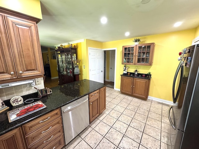 26575 N Fairfield Rd, Wauconda, IL 60084 - kitchen featuring stainless steel appliances, light tile patterned floors, glass insert cabinets, dark stone counters, and recessed lighting