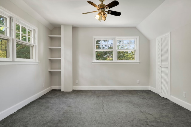 3838 Johnson Ave, Western Springs, IL 60558 - unfurnished bedroom with dark carpet, multiple windows, vaulted ceiling, and a ceiling fan