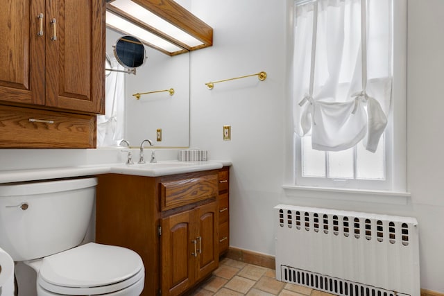 3838 Johnson Ave, Western Springs, IL 60558 - half bathroom with radiator heating unit, vanity, and stone tile floors