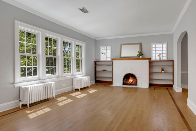 3838 Johnson Ave, Western Springs, IL 60558 - living area with radiator, arched walkways, wood finished floors, and crown molding