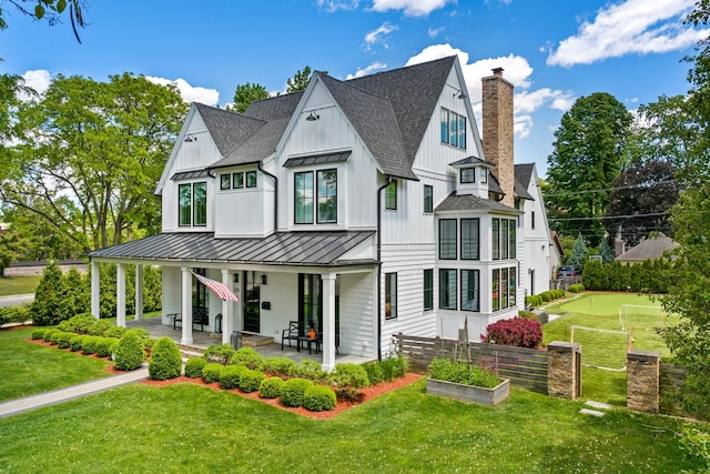 125 S Madison St, Hinsdale, IL 60521 - view of front of property with a shingled roof, a standing seam roof, a chimney, a front lawn, and board and batten siding