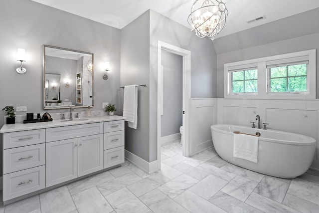 125 S Madison St, Hinsdale, IL 60521 - bathroom featuring marble finish flooring, vanity, a freestanding tub, and a chandelier