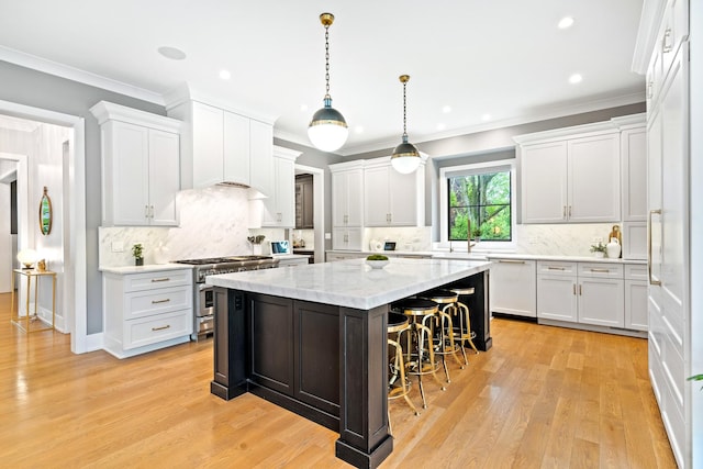 125 S Madison St, Hinsdale, IL 60521 - kitchen featuring white dishwasher, high end stove, a center island, a kitchen bar, and white cabinets