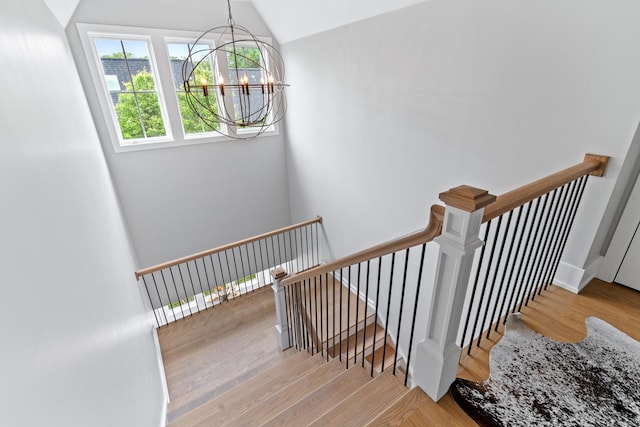 125 S Madison St, Hinsdale, IL 60521 - stairway with a chandelier, vaulted ceiling, and wood finished floors