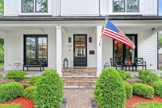 125 S Madison St, Hinsdale, IL 60521 - property entrance featuring covered porch and board and batten siding