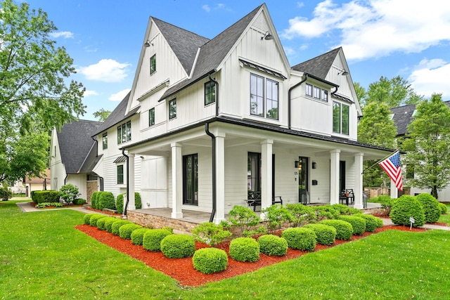 125 S Madison St, Hinsdale, IL 60521 - modern inspired farmhouse featuring board and batten siding, covered porch, a front yard, and a shingled roof