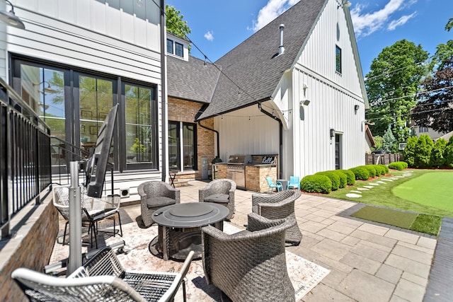 125 S Madison St, Hinsdale, IL 60521 - view of patio featuring an area to practice putting, an outdoor kitchen, and a fire pit