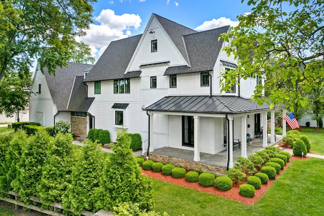 125 S Madison St, Hinsdale, IL 60521 - back of house with a standing seam roof, roof with shingles, a lawn, a metal roof, and covered porch