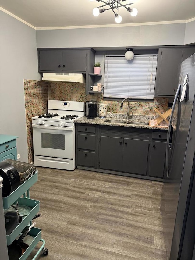 5814 S Laflin St, Chicago, IL 60636 - kitchen with white range with gas stovetop, under cabinet range hood, stainless steel fridge with ice dispenser, ornamental molding, and backsplash