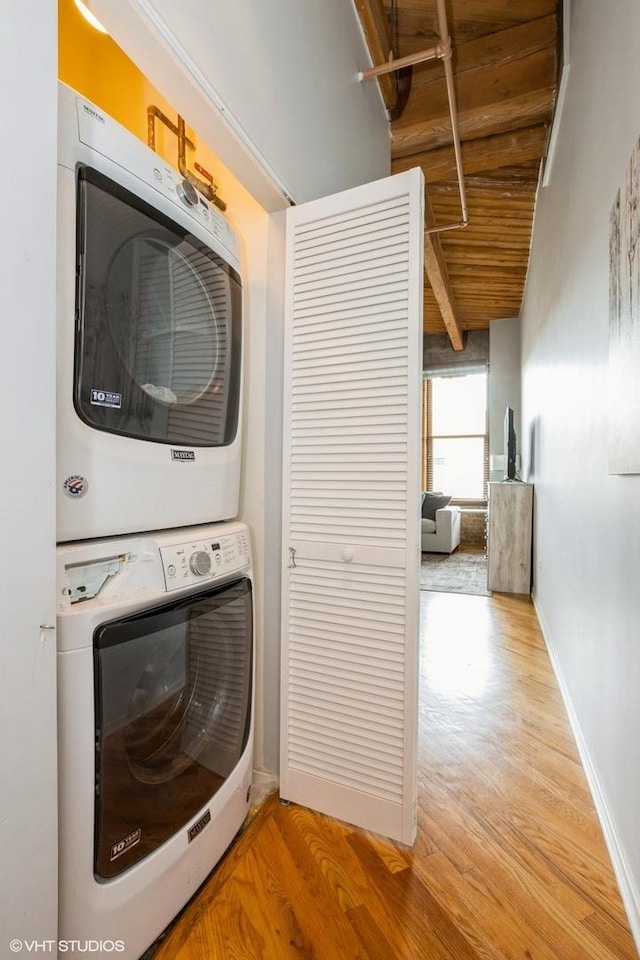 1040 W Adams St Unit 406, Chicago, IL 60607 - laundry room with stacked washing machine and dryer, light wood-style flooring, and wood ceiling