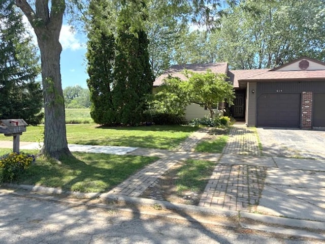 614 Lyon Ct, Buffalo Grove, IL 60089 - view of front of home with an attached garage, driveway, a front yard, and brick siding