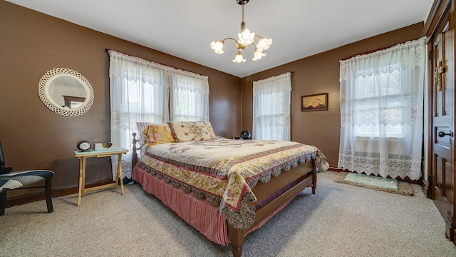 215 E 3rd St, Byron, IL 61010 - bedroom with a chandelier, light carpet, and multiple windows