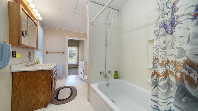 215 E 3rd St, Byron, IL 61010 - full bath featuring vanity, shower / bath combo, wood walls, and tile patterned floors