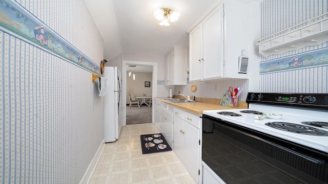 215 E 3rd St, Byron, IL 61010 - kitchen with electric stove, freestanding refrigerator, white cabinets, light countertops, and light flooring