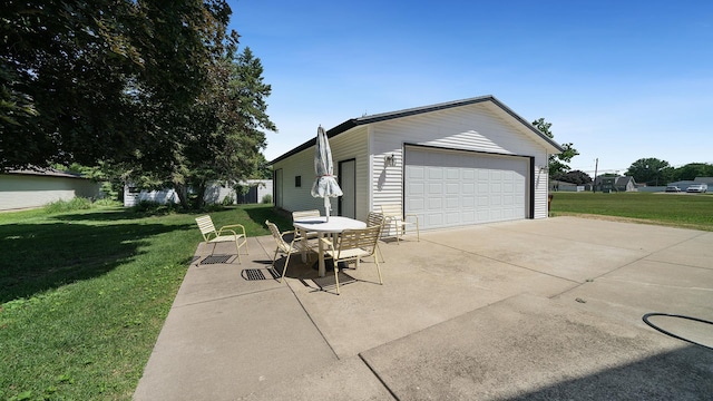 215 E 3rd St, Byron, IL 61010 - view of property exterior with a yard and a detached garage